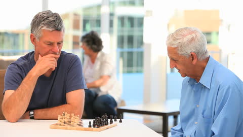 Senior Men Playing Chess, Engaging in Friendly Competition