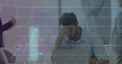 Stressed office worker holding forehead during data review with chart overlay