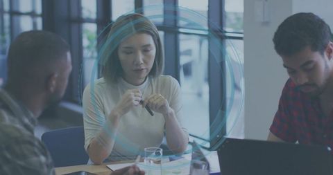 Female Professional Reviewing Charts, Documents While Collaborating in Bright Modern Office