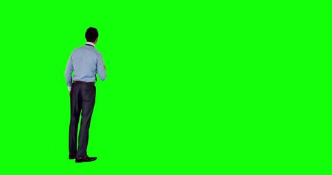 Businessman Standing in Front of Green Screen