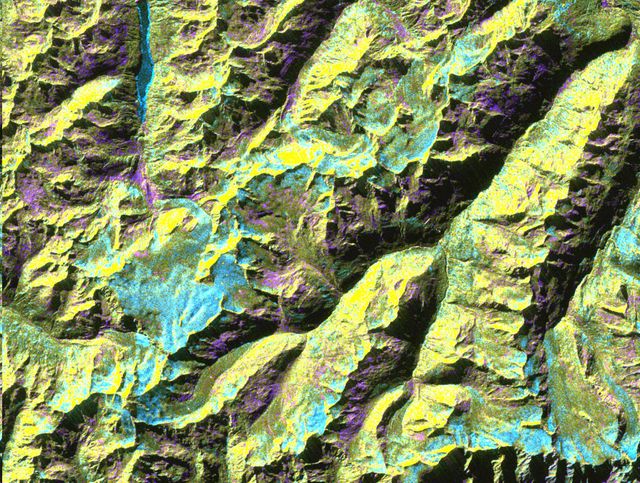 This is a digital elevation model that was geometrically coded directly onto an X-band seasonal change image of the Oetztal supersite in Austria. The image is centered at 46.82 degrees north latitude and 10.79 degrees east longitude. This image is located in the Central Alps at the border between Switzerland, Italy and Austria, 50 kilometers (31 miles) southwest of Innsbruck. It was acquired by the Spaceborne Imaging Radar-C/X-band Synthetic Aperture aboard the space shuttle Endeavour on April 14, 1994 and on October 5, 1994. It was produced by combining data from these two different data sets. Data obtained in April is green; data obtained in October appears in red and blue, and was used as an enhancement based on the ratio of the two data sets. Areas with a decrease in backscatter from April to October appear in light blue (cyan), such as the large Gepatschferner glacier seen at the left of the image center, and most of the other glaciers in this view. A light blue hue is also visible at the east border of the dark blue Lake Reschensee at the upper left side. This shows a significant rise in the water level. Magenta represents areas with an increase of backscatter from April 10 to October 5. Yellow indicates areas with high radar signal response during both passes, such as the mountain slopes facing the radar. Low radar backscatter signals refer to smooth surface (lakes) or radar grazing areas to radar shadow areas, seen in the southeast slopes. The area is approximately 29 kilometers by 21 kilometers (18 miles by 13.5 miles). The summit of the main peaks reaches elevations of 3,500 to 3,768 meters (xx feet to xx feet) above sea level. The test site's core area is the glacier region of Venter Valley, which is one of the most intensively studied areas for glacier research in the world. Research in Venter Valley (below center) includes studies of glacier dynamics, glacier-climate regions, snowpack conditions and glacier hydrology. About 25 percent of the core test site is covered by glaciers. Corner reflectors are set up for calibration. Five corner reflectors can be seen on the Gepatschferner and two can be seen on the Vernagtferner.  http://photojournal.jpl.nasa.gov/catalog/PIA01760