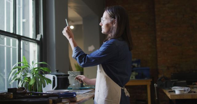 Female Artisan Working on Craft in Studio Near Window - Download Free Stock Images Pikwizard.com