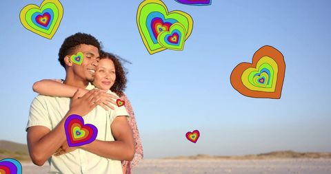 Diverse Couple Embracing at Beach with Floating Digital Hearts