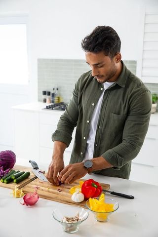 Young Man Preparing Fresh Vegetables in Modern Kitchen