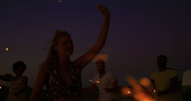 Joyful Friends Dancing with Sparklers on Sunset Beach - Download Free Stock Images Pikwizard.com