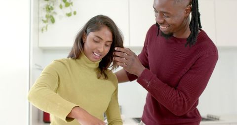 Diverse Couple Cooking Together in Bright Minimalist Kitchen Sharing Warm, Intimate Moment