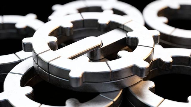 Stacking interlocking brushed steel rings reflecting light, industrial mechanical cog macro