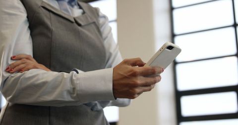 Businesswoman Holding Smartphone in Office Environment