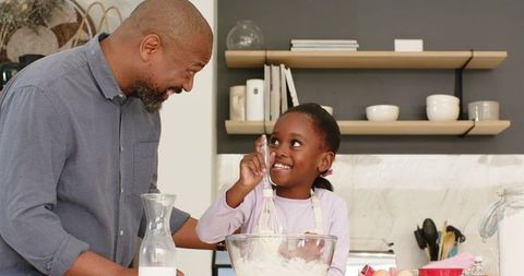 Father and Daughter Enjoying Wholesome Baking Activity