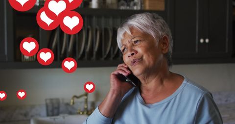 Senior Woman on Phone with Heart Reaction Icons