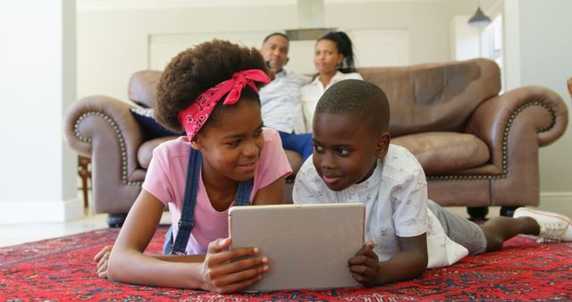 Siblings Enjoying Tablet Time on Living Room Floor - Download Free Stock Images Pikwizard.com