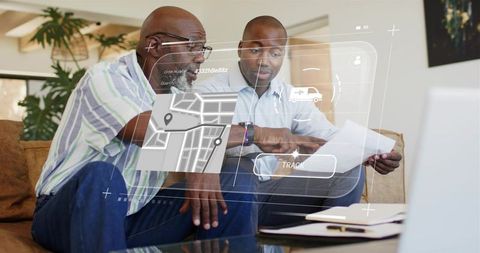 Two men reviewing delivery tracking map on laptop with augmented reality interface