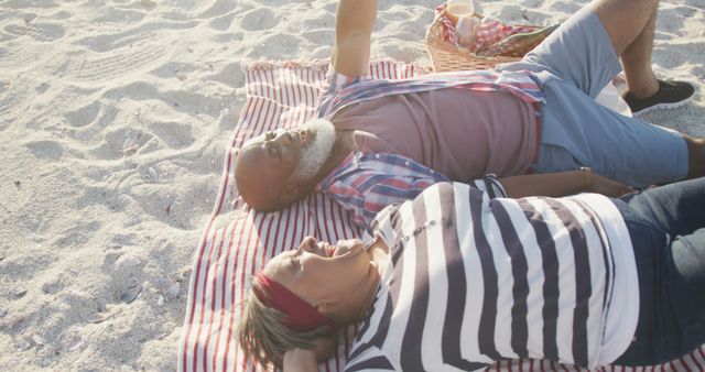 Senior Couple Relaxing on Beach with Picnic Blanket - Download Free Stock Images Pikwizard.com