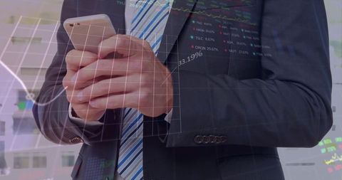 Executive holding smartphone with financial chart overlay, mobile trading and analytics