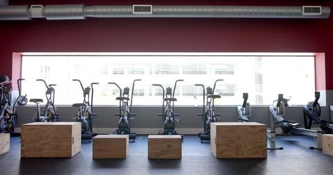 Modern gym interior featuring cardio machines