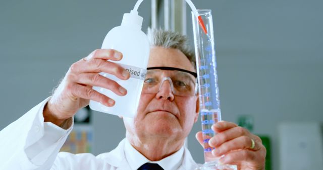 Senior Scientist in Laboratory Measuring Liquid in Graduated Cylinder - Download Free Stock Images Pikwizard.com