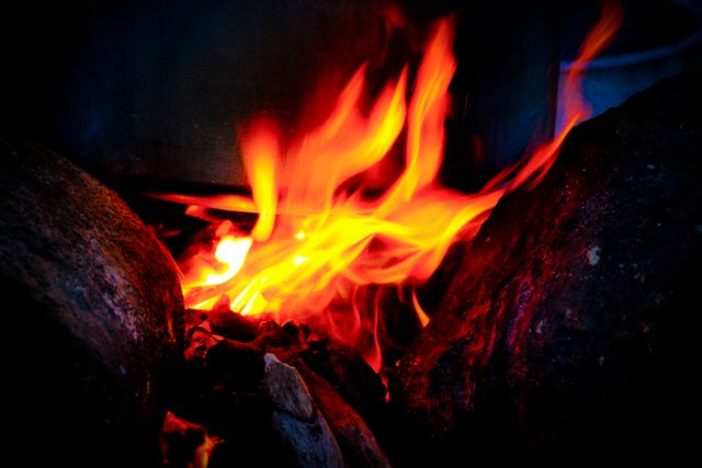 Close-up of Brightly Burning Flames Among Rocks - Download Free Stock Photos Pikwizard.com