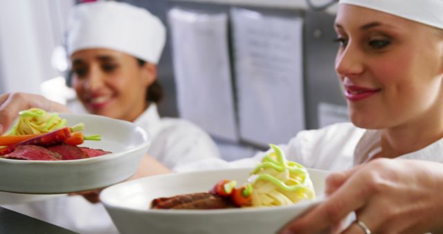 Female Chefs Preparing and Serving Gourmet Dishes in Restaurant Kitchen - Download Free Stock Images Pikwizard.com