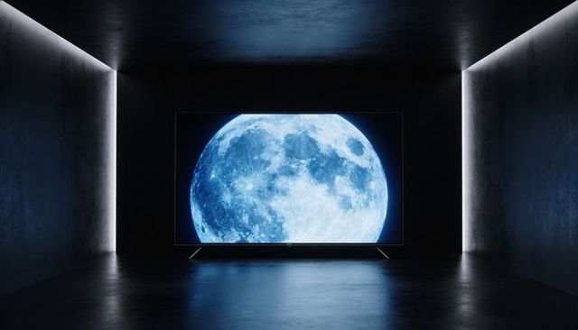 Displaying full blue moon on large flat-panel screen in minimalist dark gallery