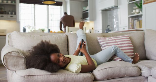 Happy Young Girl Relaxing on Cozy Couch While Using Smartphone - Download Free Stock Images Pikwizard.com