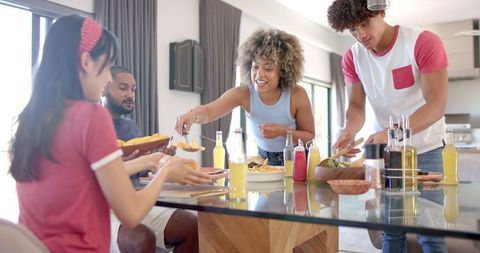 Diverse Group of Friends Sharing Meal in Modern Dining Room