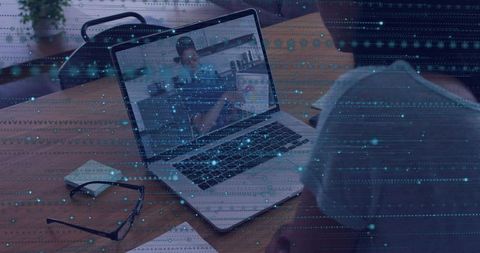 Woman watching virtual presentation on laptop with digital data overlay at wooden desk