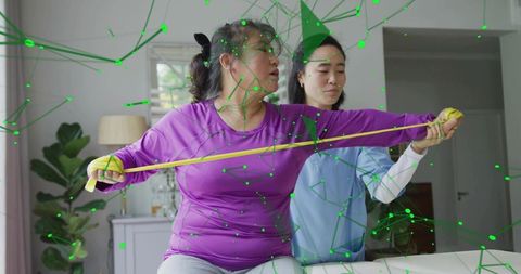 Home rehab session showing woman stretching with resistance band with therapist assisting