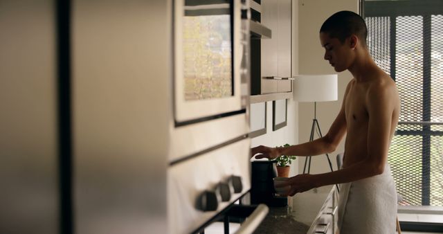 Young Man Preparing Breakfast in Modern Home Kitchen - Download Free Stock Images Pikwizard.com