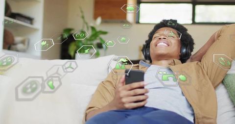 Relaxed Man Enjoying Music with Eco-Friendly Technology Holograms