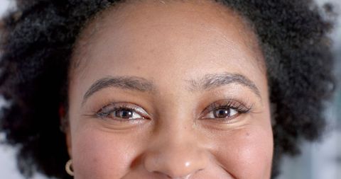 Close-up Portrait of Smiling Medical Professional with Natural Curly Hair