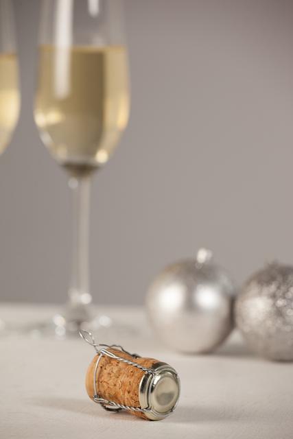 Champagne Cork and Glasses with Christmas Ornaments - Download Free Stock Photos Pikwizard.com