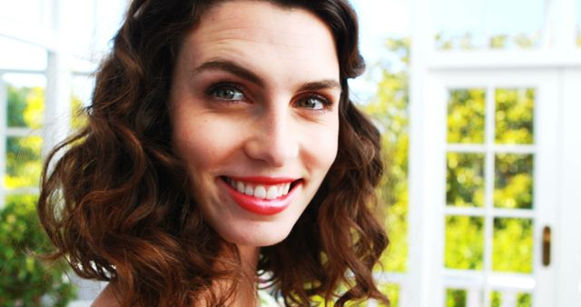 Smiling Young Woman with Curly Hair in Bright Natural Light - Download Free Stock Images Pikwizard.com