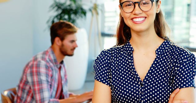 Smiling Woman with Glasses in Office with Colleague Working - Download Free Stock Images Pikwizard.com