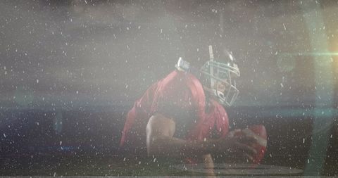 Football Player Holding Ball During Action on Rainy Field - Download Free Stock Images Pikwizard.com