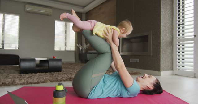 Caucasian mother playing with her baby while practicing yoga on yoga mat at home - Download Free Stock Photos Pikwizard.com