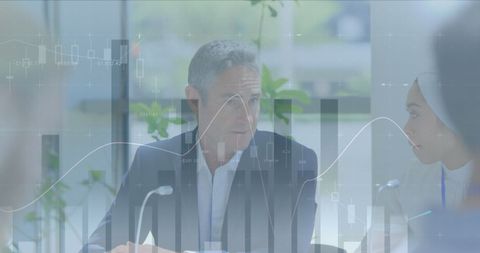 Business Team Analyzing Data with Transparent Charts Overlay