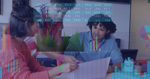 Collaborating on dashboards, team analyzing charts with overlays in office