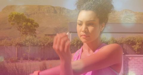 Woman exercising outdoors in pink workout gear