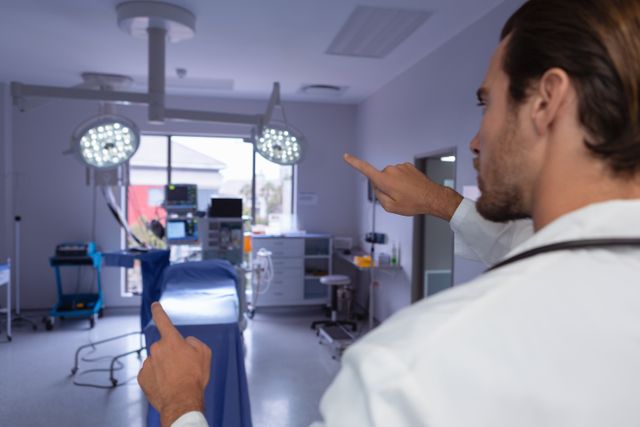 Doctor interacting with an invisible screen in a modern operating room. Ideal for illustrating advanced medical technology, healthcare innovation, and professional medical environments. Can be used in healthcare articles, medical technology promotions, and hospital brochures.