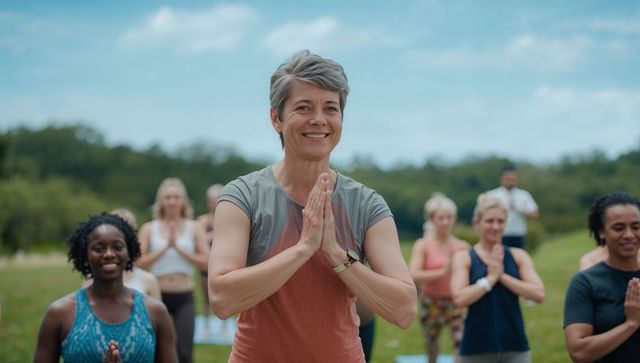 Smiling Senior Woman Enjoying Group Yoga in Outdoor Park