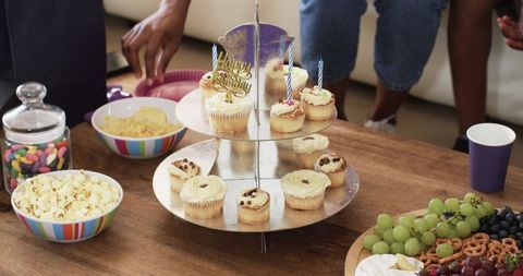 African american family birthday gathering with cupcake stand and casual home celebration