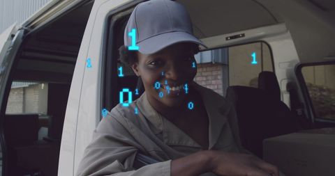 Smiling woman in logistics van with binary overlay technology concept
