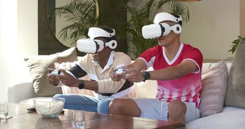 Men Immersed in VR Gaming with Headsets and Controllers in Cozy Setting