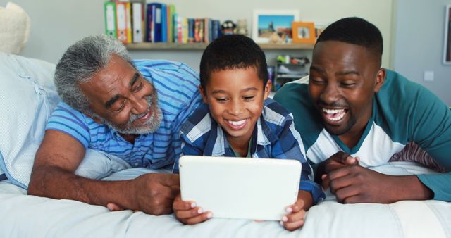 Three Generations Enjoying Tablet Together on Bed - Download Free Stock Images Pikwizard.com