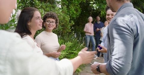Garden wedding celebration with smiling guests in lush setting