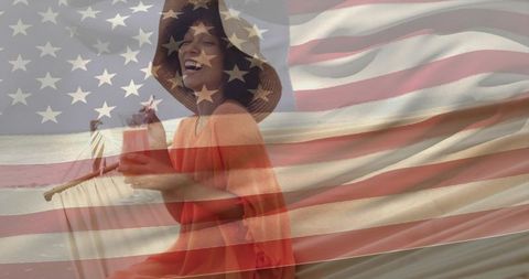 Joyful woman in straw hat enjoying tropical beach cocktail with american flag overlay