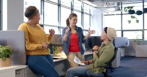Team Collaborating in Modern Open-Plan Office with Casual Dress and Natural Light