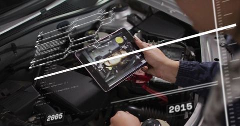 Technician using augmented reality tablet for engine diagnostics