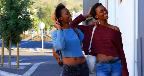 Joyful African American Twin Sisters Exploring City Streets