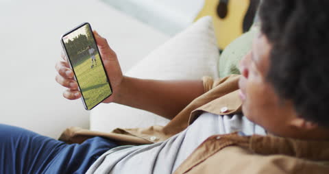 Man Watching Soccer Video on Smartphone